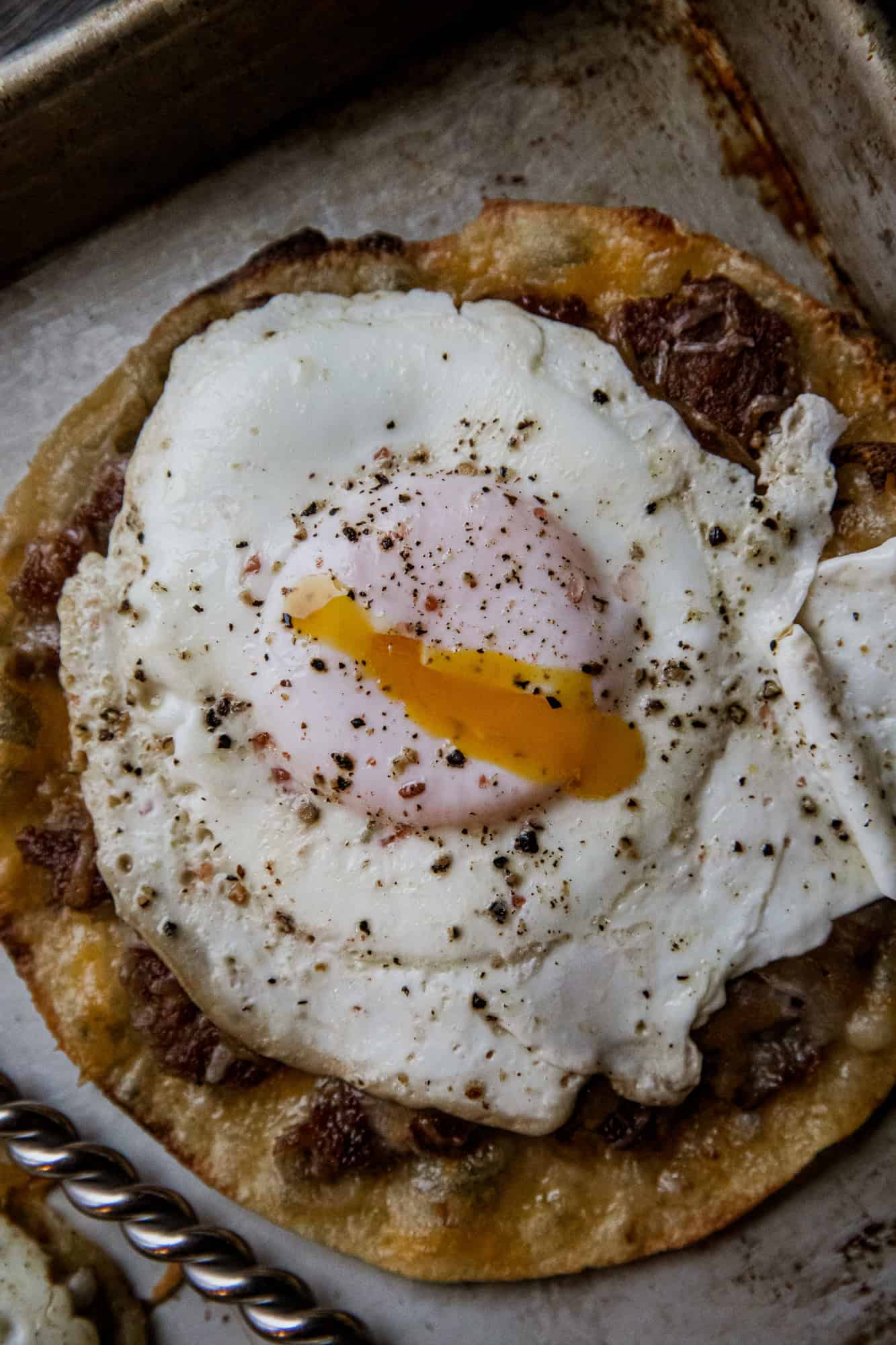 Breakfast tacos with fried egg on a crispy tortilla.